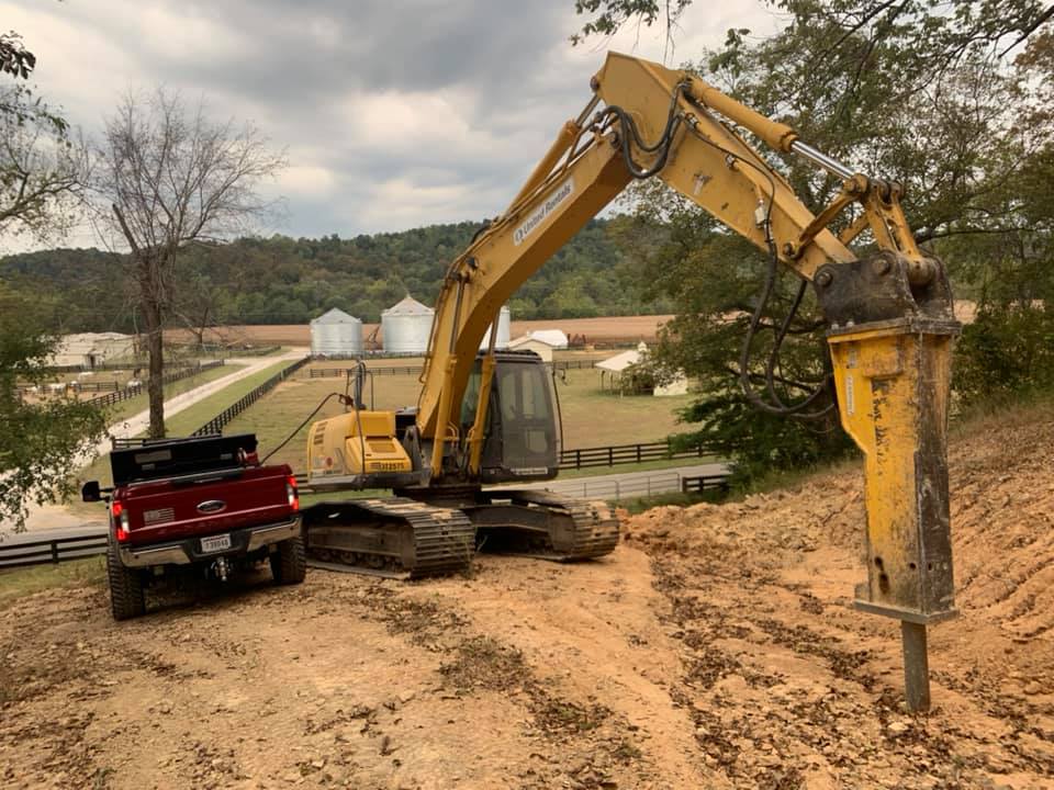 Excavator grading land at a Nashville construction site